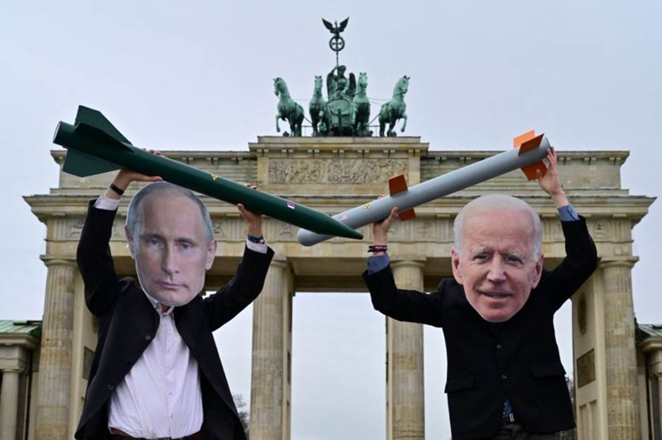 Activists wearing masks of Russian President Vladimir Putin and U.S. President Joe Biden pose with mock nuclear missiles in front of the Brandenburg Gate in Berlin on Jan. 29, 2021.