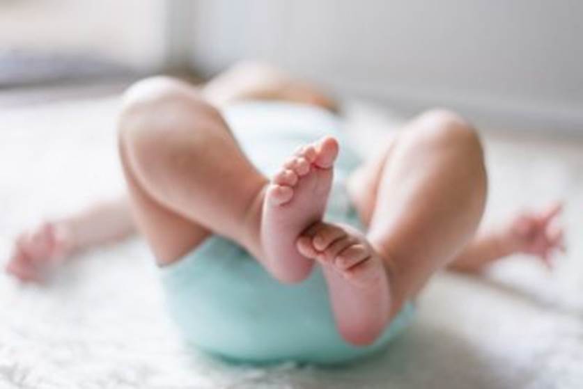 A close-up of a baby's feet  Description automatically generated