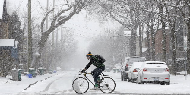 a man rides a bicycle during a snow storm in ottawa canada photo reuters