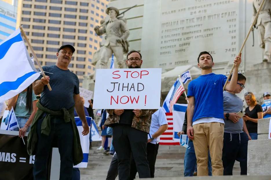 Max Profeta, center, held up a Stop Jihad Now sign at a pro-Israel demonstration across the street from a pro-Palestinian rally on Thursday in downtown Indianapolis.