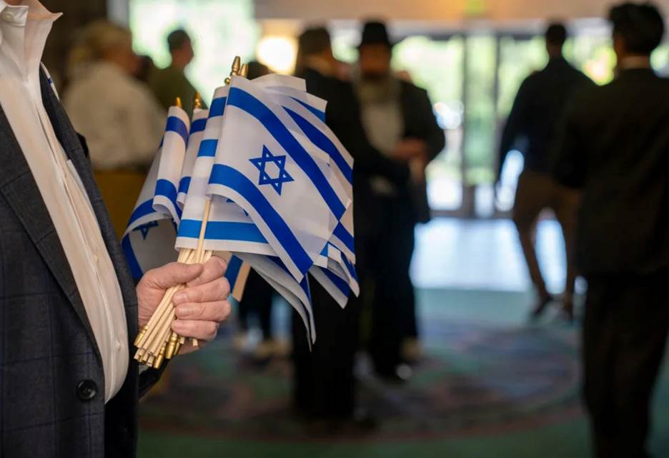 Miniature flags of Israel were handed out at the entrance to a solidarity gathering at Congregation Beth-El Zedeck in Indianapolis on Monday