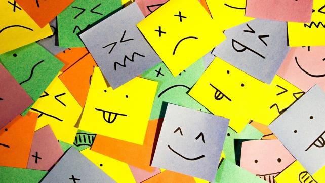 A group of post it notes with drawn faces  Description automatically generated with low confidence