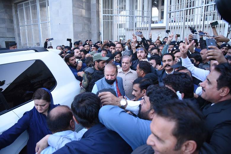 Pakistan's former Prime Minister Nawaz Sharif surrounded by a large group of people outside the high court in Pakistan.