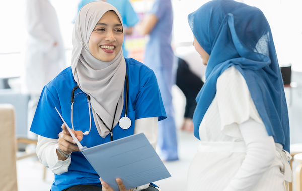 Muslim doctor talking with a Muslim woman.