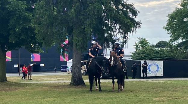 Two police officers on horses  Description automatically generated