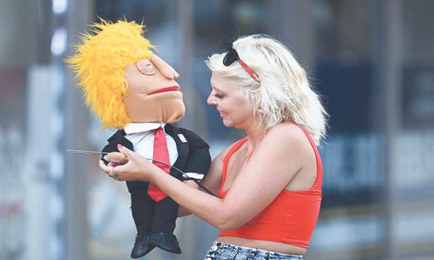 MILWAUKEE (Wisconsin, US): A woman holds a Donald Trump puppet ahead of the Republican National Convention, on Monday.—AFP