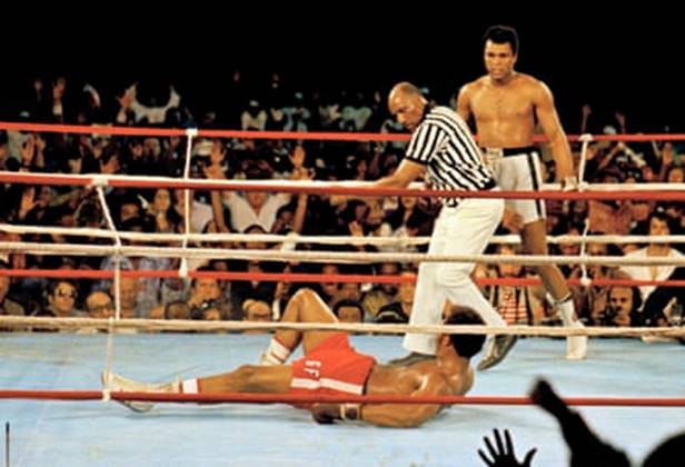 Muhammad Ali stands back as the referee, Zack Clayton, calls the count over George Foreman in the eighth round.