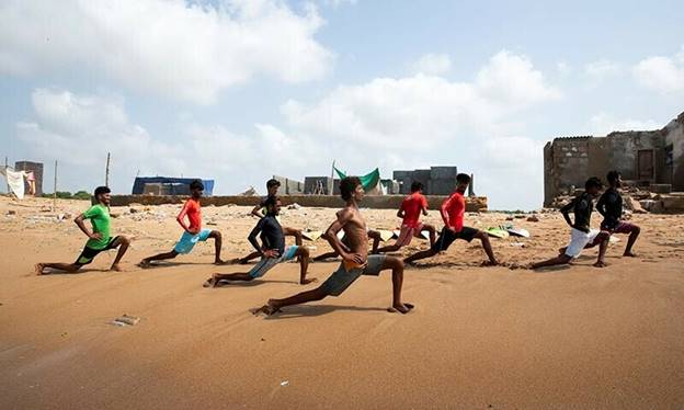 Surfers warm up and stretch as they prepare to surf at Turtle Beach in Karachi, on Sept 4, 2024. — Reuters