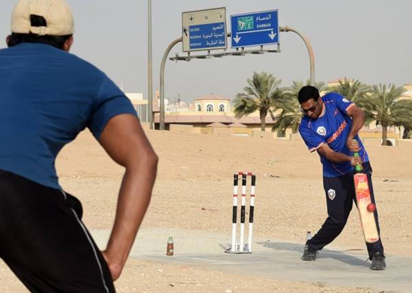 Expats in Saudi Arabia play cricket in the parking lot of a mall, September 12, 2015