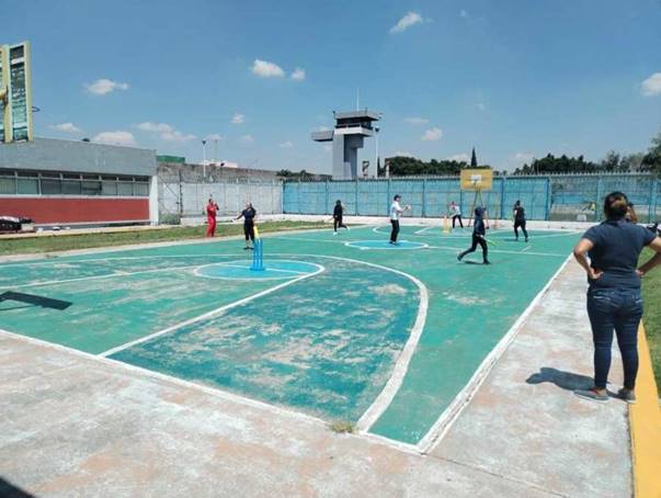 A basketball court does double duty as a cricket pitch in a prison in Mexico