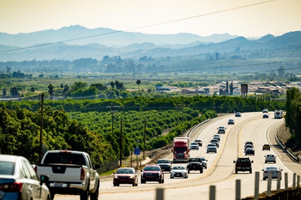 A highway with many cars and trees  AI-generated content may be incorrect.
