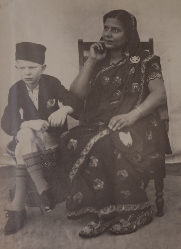 A person sitting next to a child  AI-generated content may be incorrect.