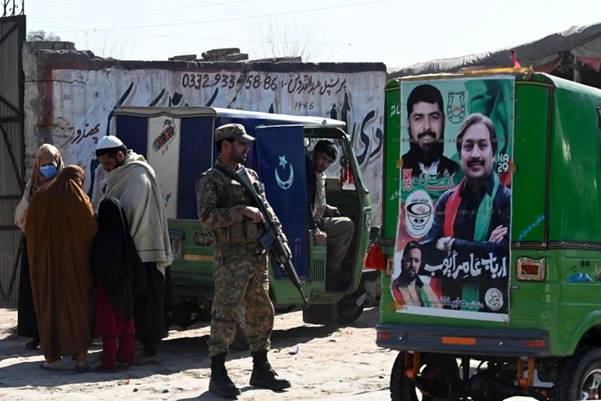 A soldier outside a polling station during Pakistan's national elections in Peshawar