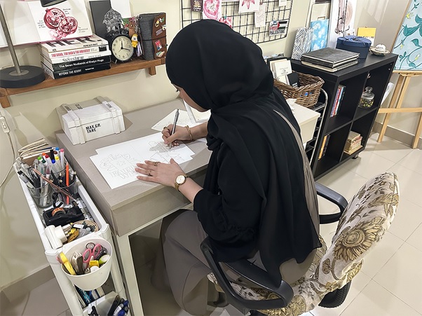 A person sitting at a desk writing on paper  AI-generated content may be incorrect.