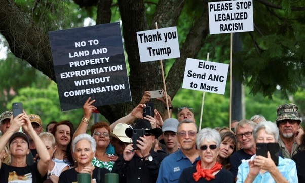Demonstrators hold placards in support of US President Donald Trump’s stance against what he calls racist laws, land expropriation, and farm attacks, outside the American Embassy in Pretoria, South Africa, February 15, 2025. — Reuters/File