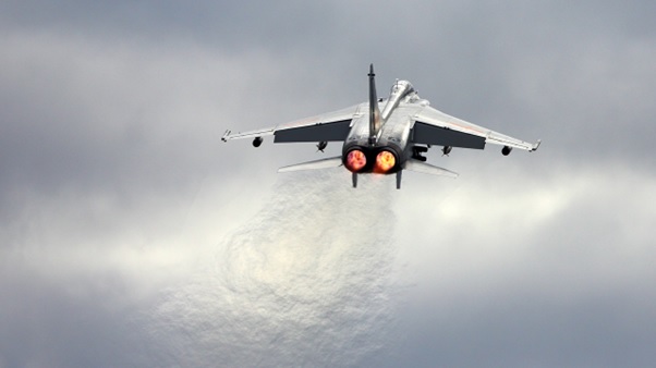 A plane flying in a cloudy sky.