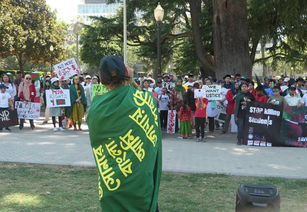 A group of people protesting  Description automatically generated