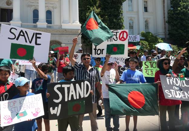 A group of people holding signs  Description automatically generated