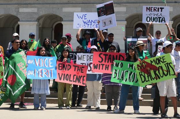 A group of people holding signs  Description automatically generated