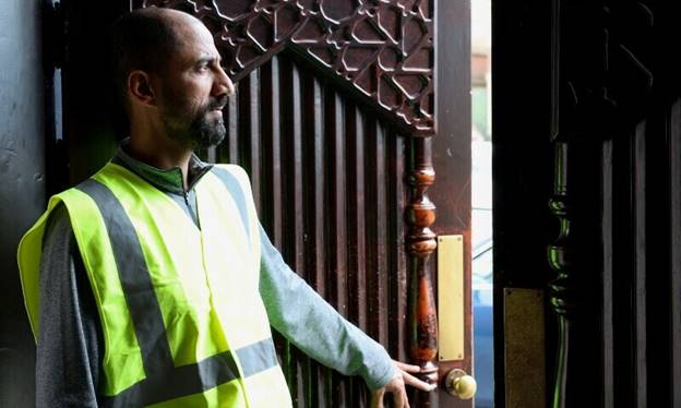 A volunteer monitors the surroundings of the Al Rahma Mosque, amid rioting across the country in which mosques and Muslims have been targets, in Liverpool, Britain, August 6. — Reuters