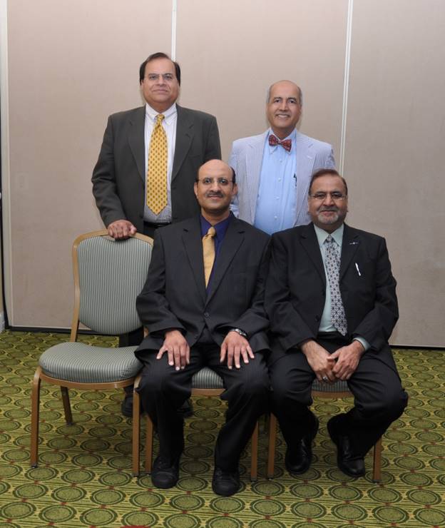 A group of men sitting in chairs  Description automatically generated