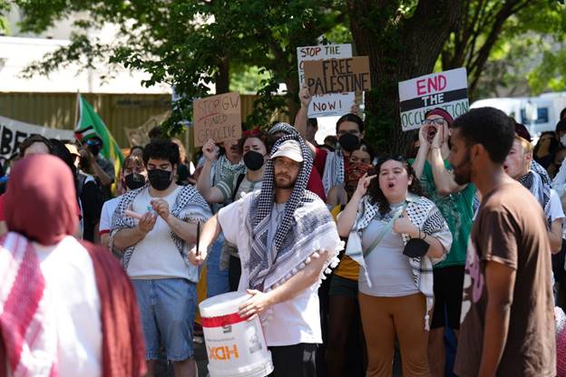 A group of people protesting  Description automatically generated