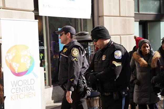 A group of police officers walking on the street  Description automatically generated