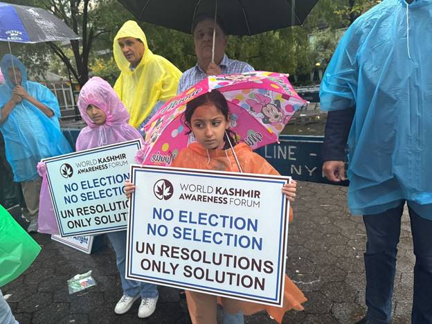 A group of people holding signs  Description automatically generated