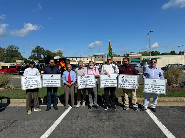 A group of people holding signs  Description automatically generated