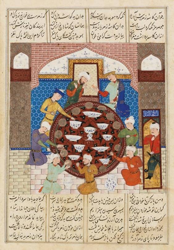 An illustration from a manuscript shows people dining during a lavish feast