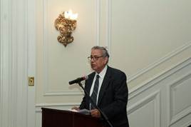 A person standing at a podium  AI-generated content may be incorrect.