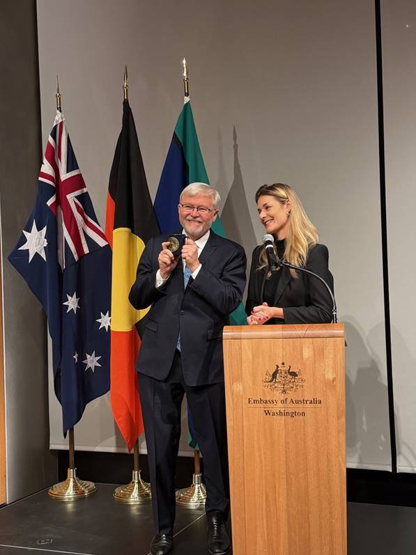 A person and person standing at a podium  AI-generated content may be incorrect.