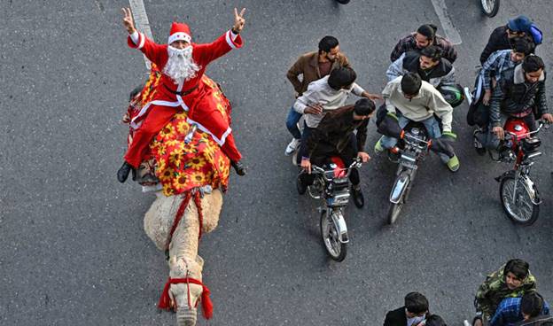 A person riding a camel with people on it  AI-generated content may be incorrect.