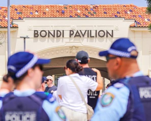 Police officers amid crowds of mourners in Bondi yesterday.