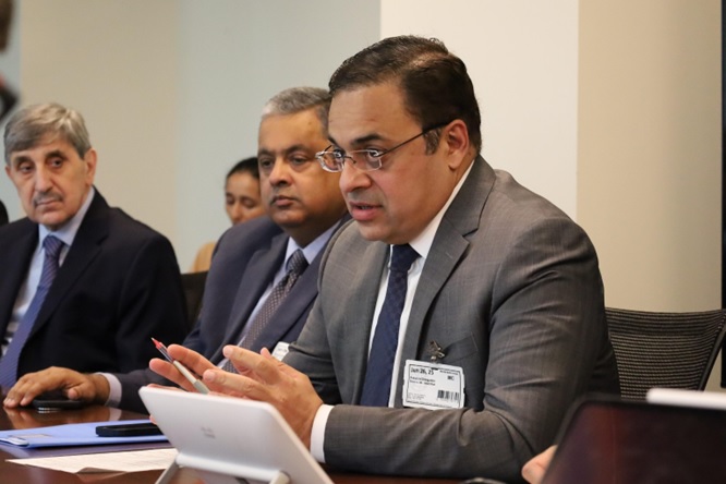 A group of men sitting at a table  AI-generated content may be incorrect.