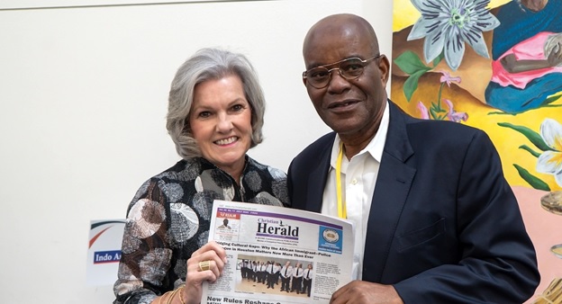 A person and person holding a newspaper  AI-generated content may be incorrect.