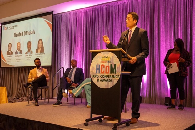 A person standing at a podium  AI-generated content may be incorrect.