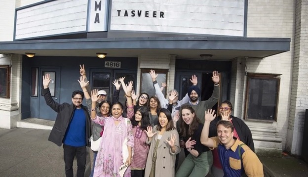 A group of people posing for a photo outside of a building  AI-generated content may be incorrect.