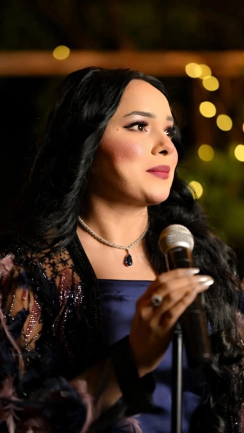 A person holding a microphone  AI-generated content may be incorrect.