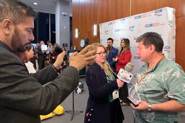 A person taking a picture of a person with microphones  AI-generated content may be incorrect.