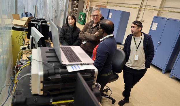 A group of people looking at a computer  AI-generated content may be incorrect.