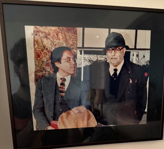 A framed picture of men in suits  AI-generated content may be incorrect.