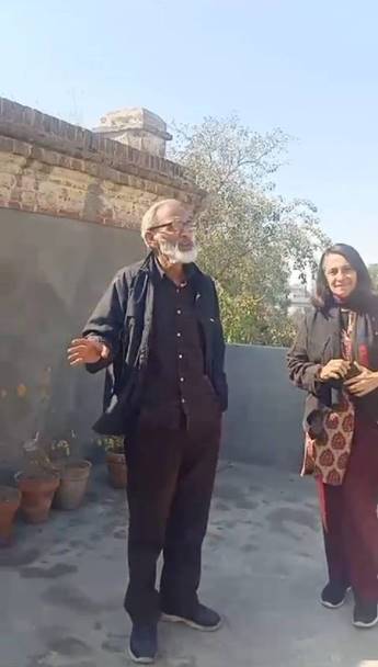 Two people stand on a rooftop