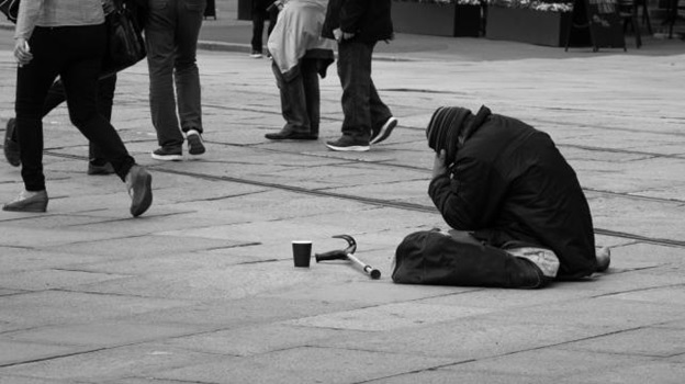 A person sitting on the ground with a hammer and a cup  AI-generated content may be incorrect.