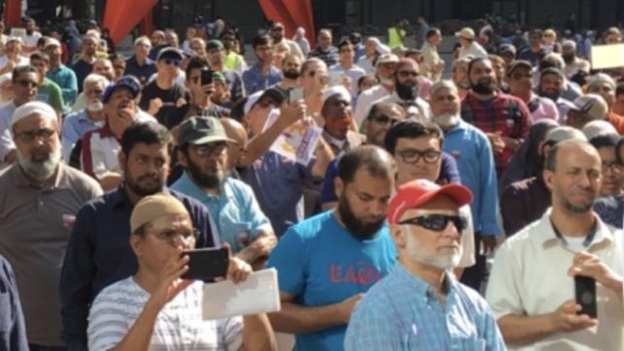 A group of people standing in a crowd  AI-generated content may be incorrect.