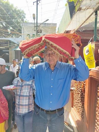 A person holding a red and white cloth over his head  AI-generated content may be incorrect.
