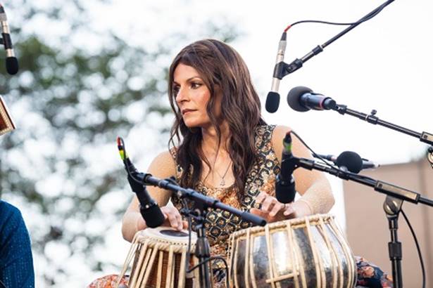 A person playing drums with microphones  AI-generated content may be incorrect.